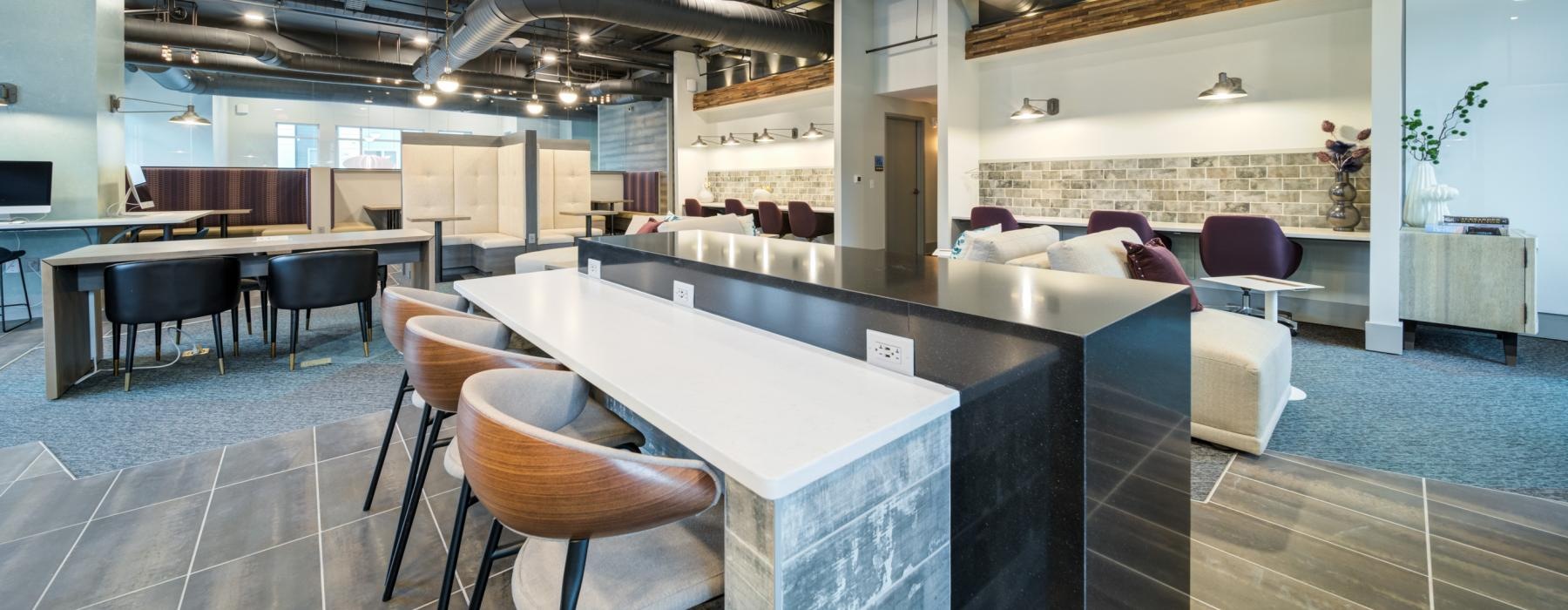 a large room with a bar and chairs